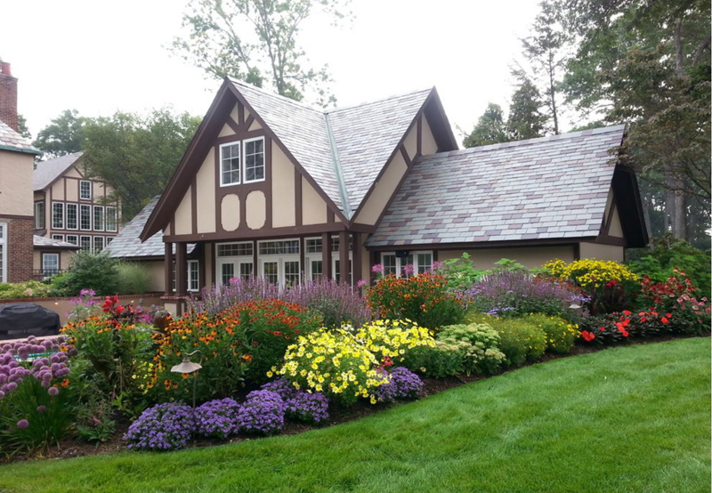 Flowering plants in front of a country house