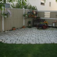 Playground in the corner of the garden from homemade concrete tiles