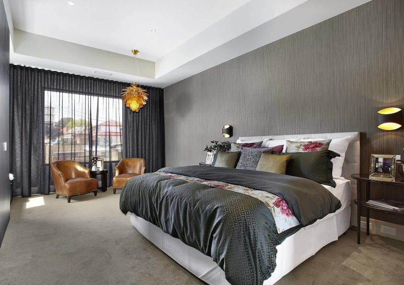 Gray translucent curtains in the interior of a dark bedroom