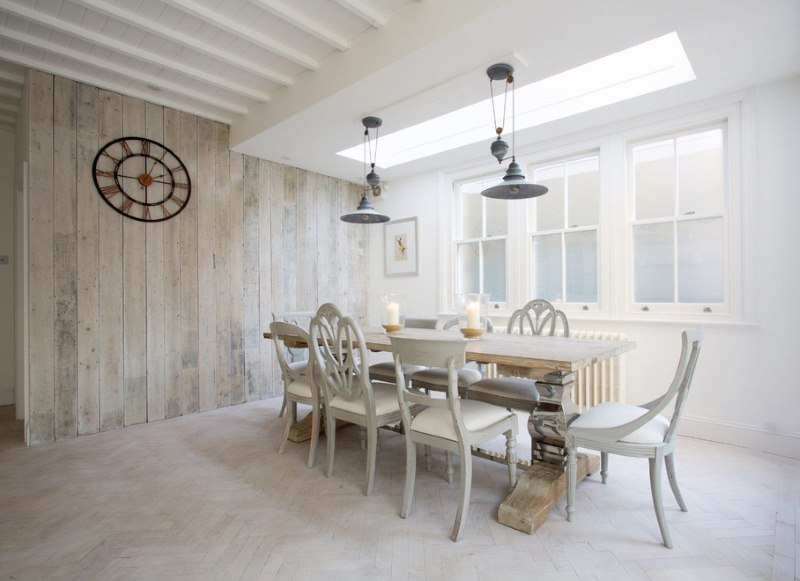 White living room of a private house with a lighted laminate on the wall