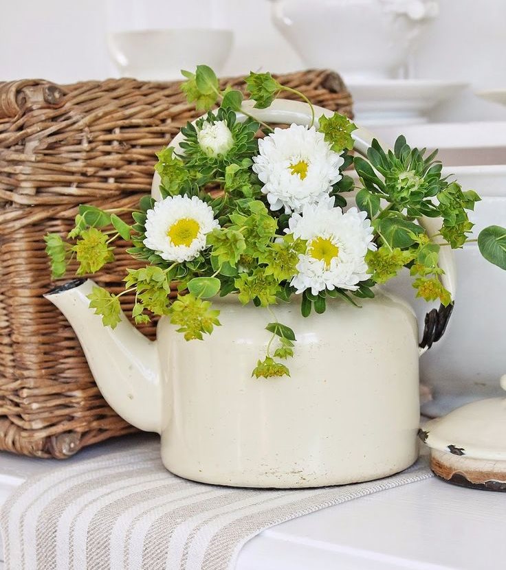 Vase from an old kettle in the interior of the kitchen