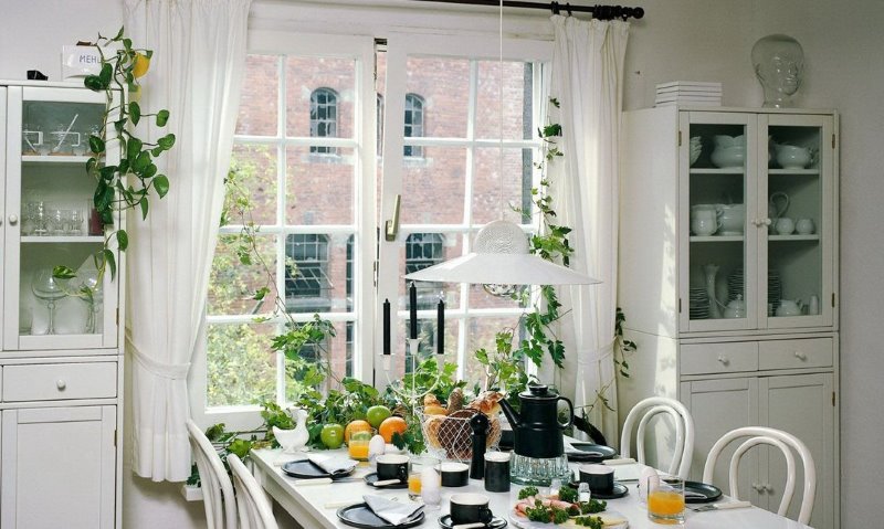 Decorative curtains on a rustic kitchen window