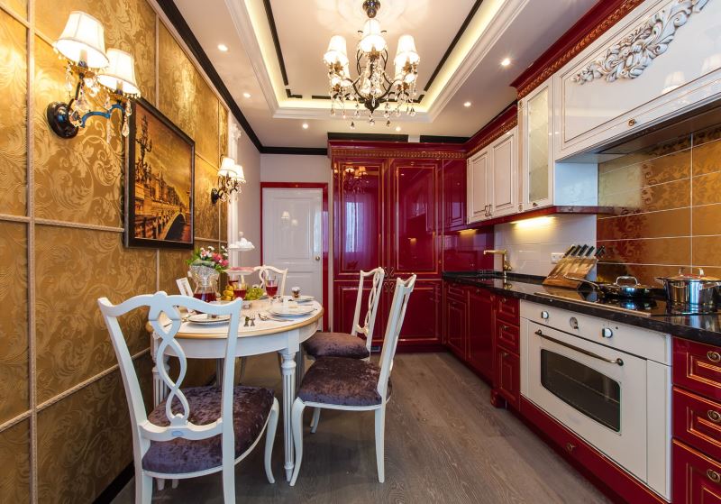 Elongated kitchen with golden wallpaper print