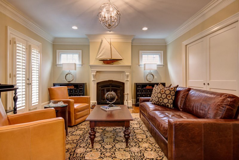 Tan chairs in the living room with a dark brown sofa