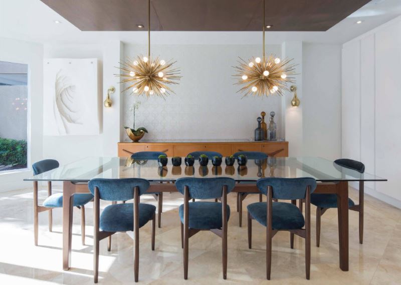 Two original chandeliers over a glass table