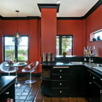 Black kitchen set on a background of cherry walls