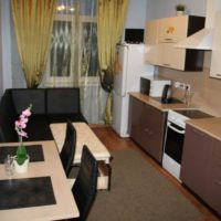 Black corner sofa in the kitchen interior