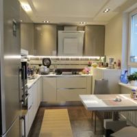 a small dining table near the kitchen window