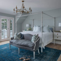 Pastel-colored bedroom interior with ceiling chandelier