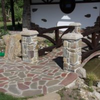 A bridge of stone through a garden stream