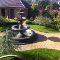 Fountain in front of the house on a country plot