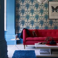 Beautiful prints on floral wallpaper over the sofa