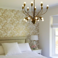 White textile bed and open lamp chandelier