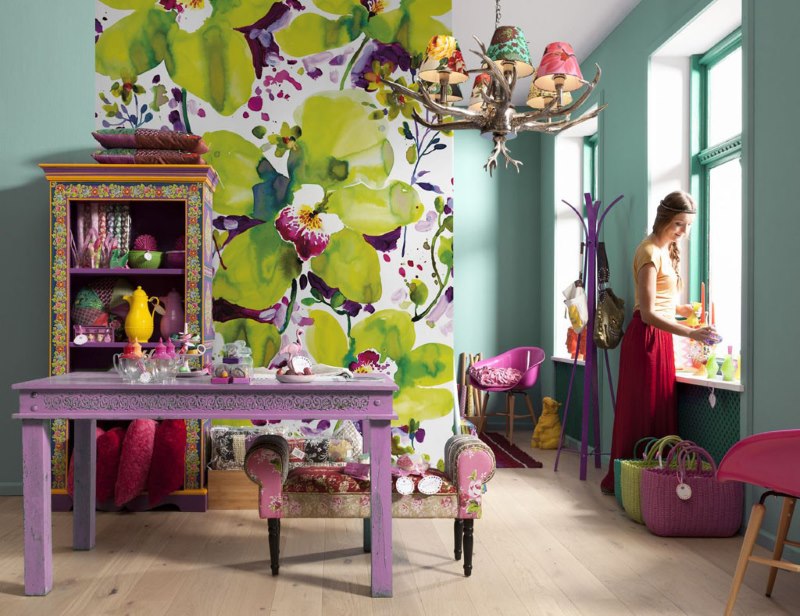 Wall mural with large flowers in the interior of the living room of a private house