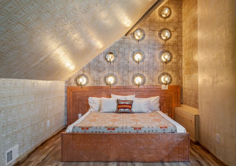 Lighting in the bedroom with golden wallpaper