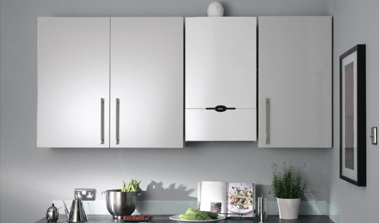 White gas boiler between the cabinets of the kitchen set