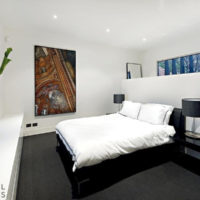 Black bed in studio apartment