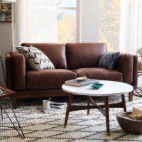 Round table in front of a brown sofa