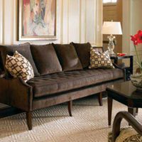 Lamps with white lampshades on the edges of the brown sofa