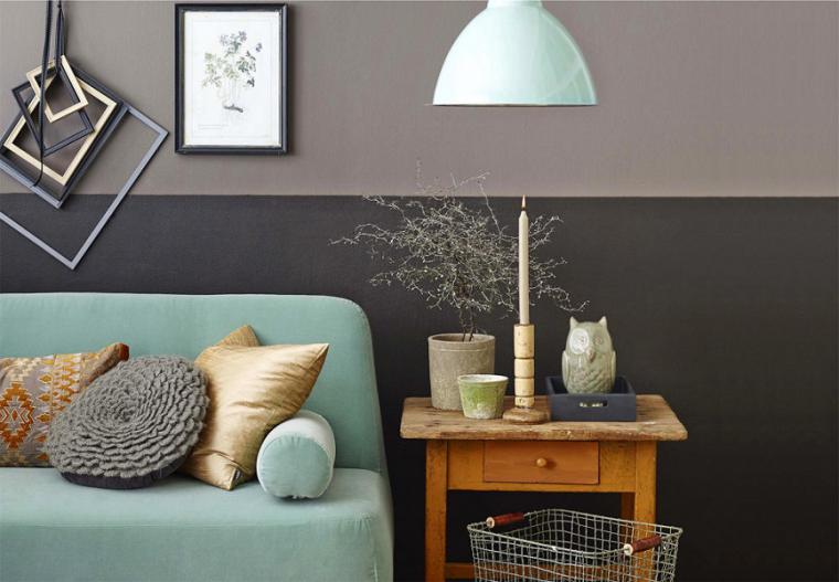 Brown wooden table next to a mint sofa