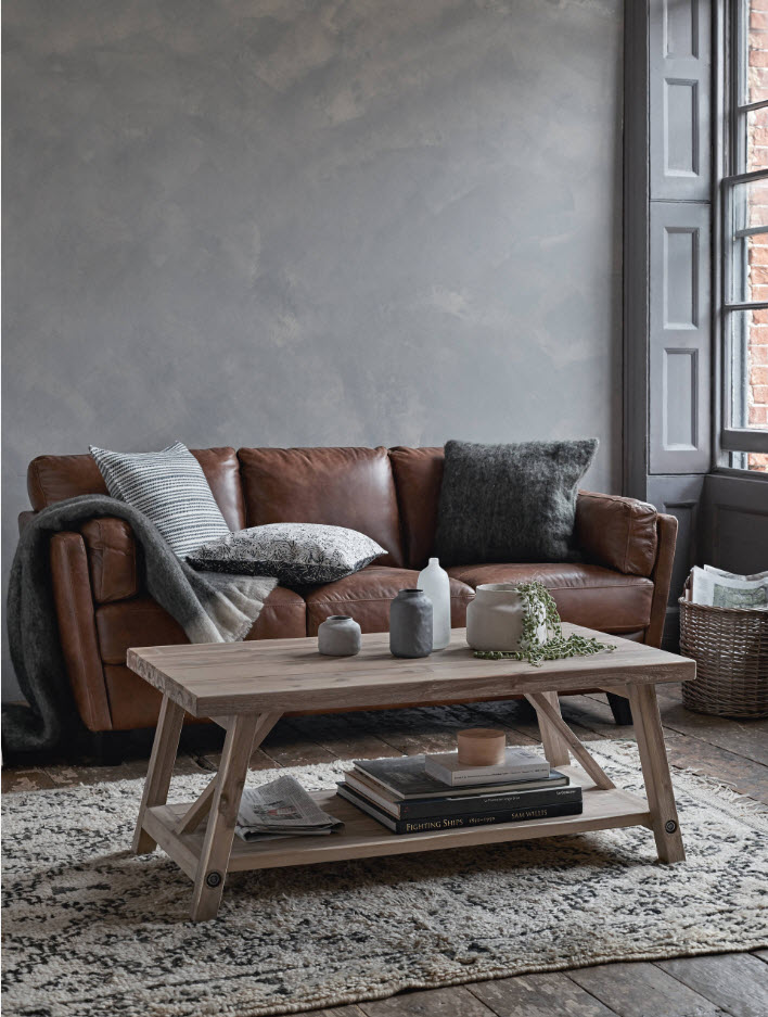 Wooden table in front of a brown sofa