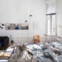 Black armchair in a white bedroom