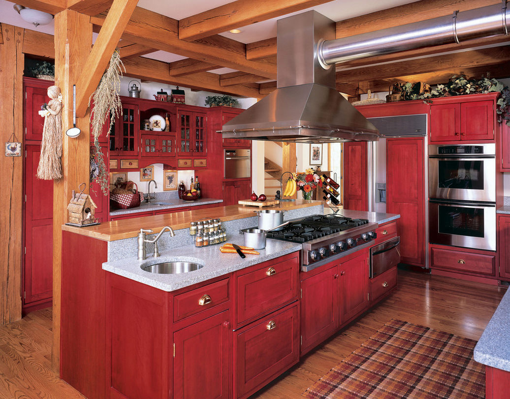 The interior of the kitchen in a country style with a predominance of red