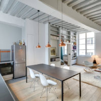 Lamps with copper shades on the ceiling with wooden beams