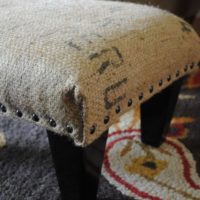 Drapery stool with rough burlap