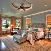 Spacious bedroom of a private house with burlap curtains