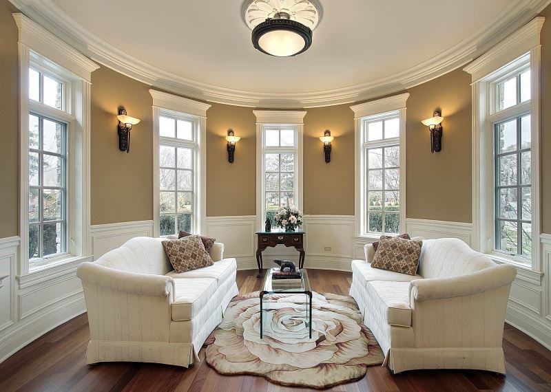 Minimalist living room interior of a private house with a chandelier in the center of the ceiling