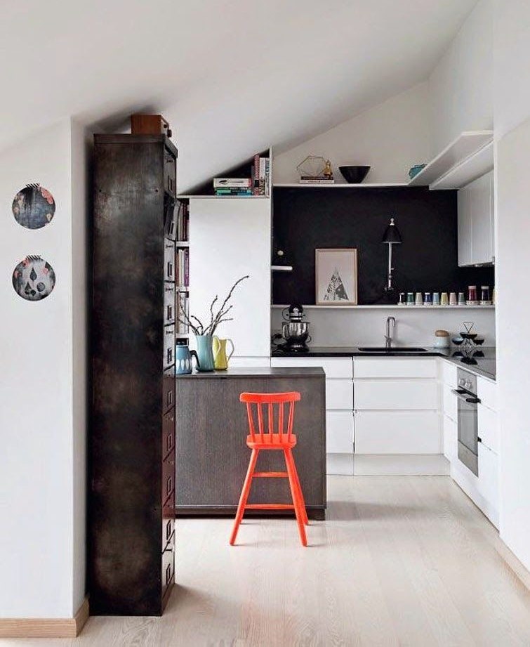 The interior of the kitchen with a sloping ceiling in the attic of a private house