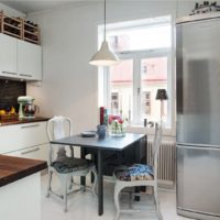 Stainless steel refrigerator in the interior of the kitchen