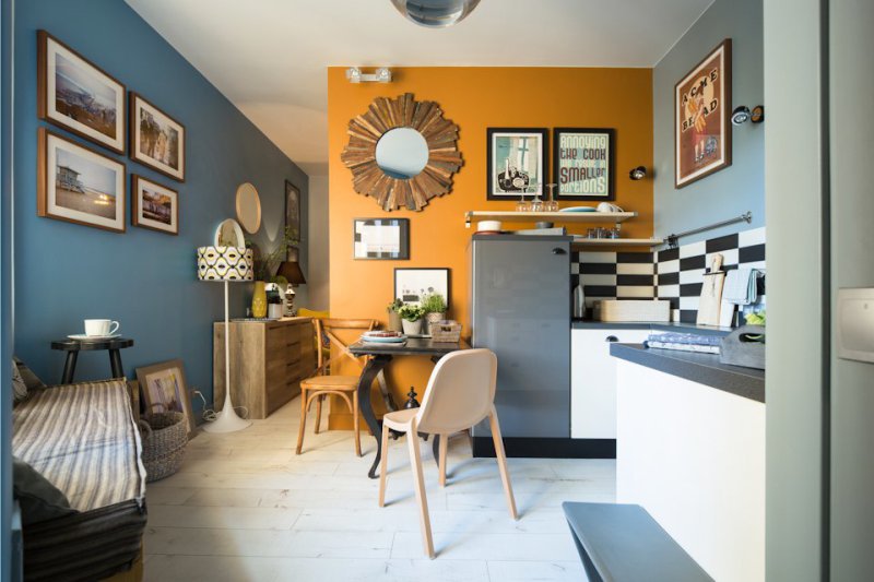 Posters on the wall of the kitchen near the dining table