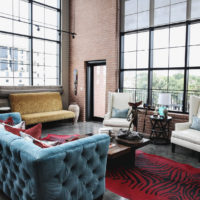 Blue sofa in the living room with panoramic windows