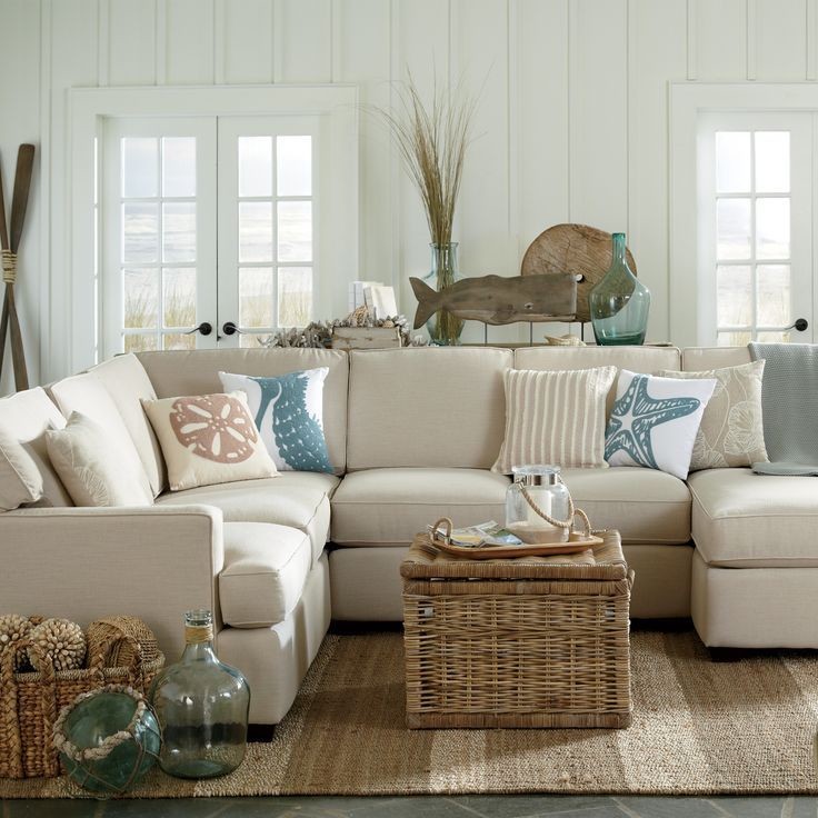 Sofa with natural upholstery in the interior of the living room of a country house