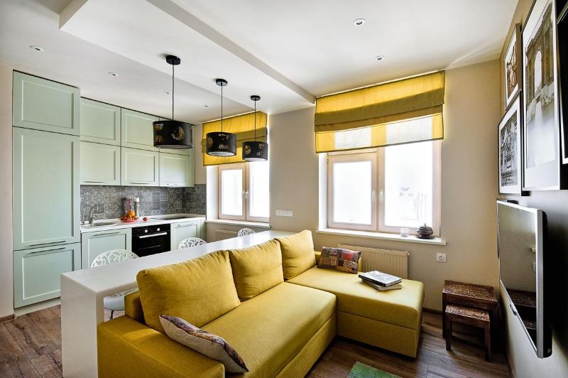 Yellow sofa in the design of a studio apartment