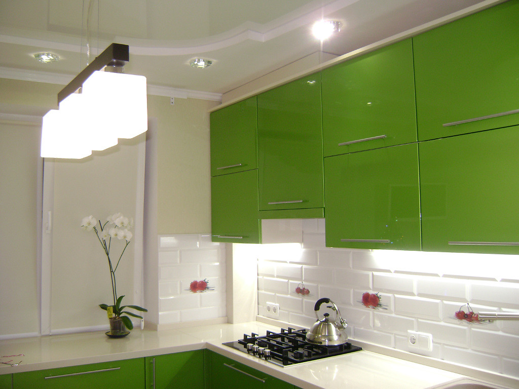 Interior of a white kitchen with a green set