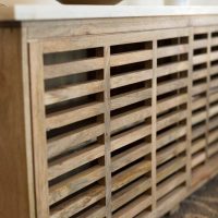 Lattice screen of wooden planks on a heating battery