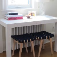 A small table in front of the window in the children's room