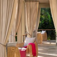 Outdoor terrace with beige curtains