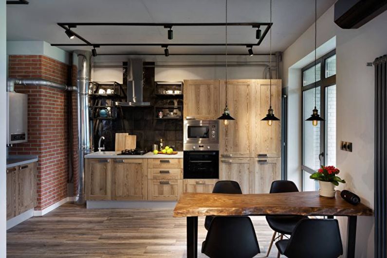 Industrial style kitchen interior with black chairs