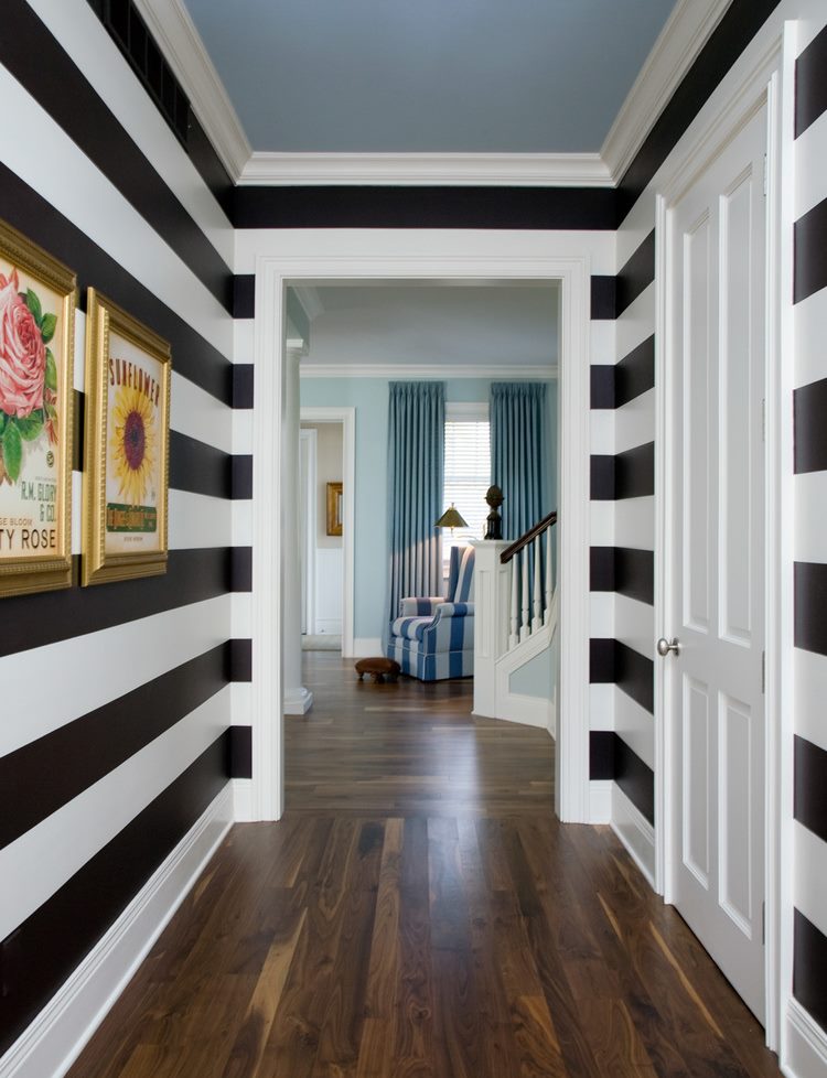 Black horizontal stripes on the wall of a narrow corridor