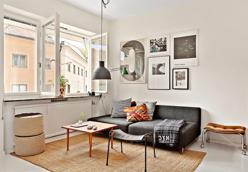 Bright living room interior with black sofa