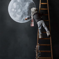 A boy draws the moon on the wall of his room