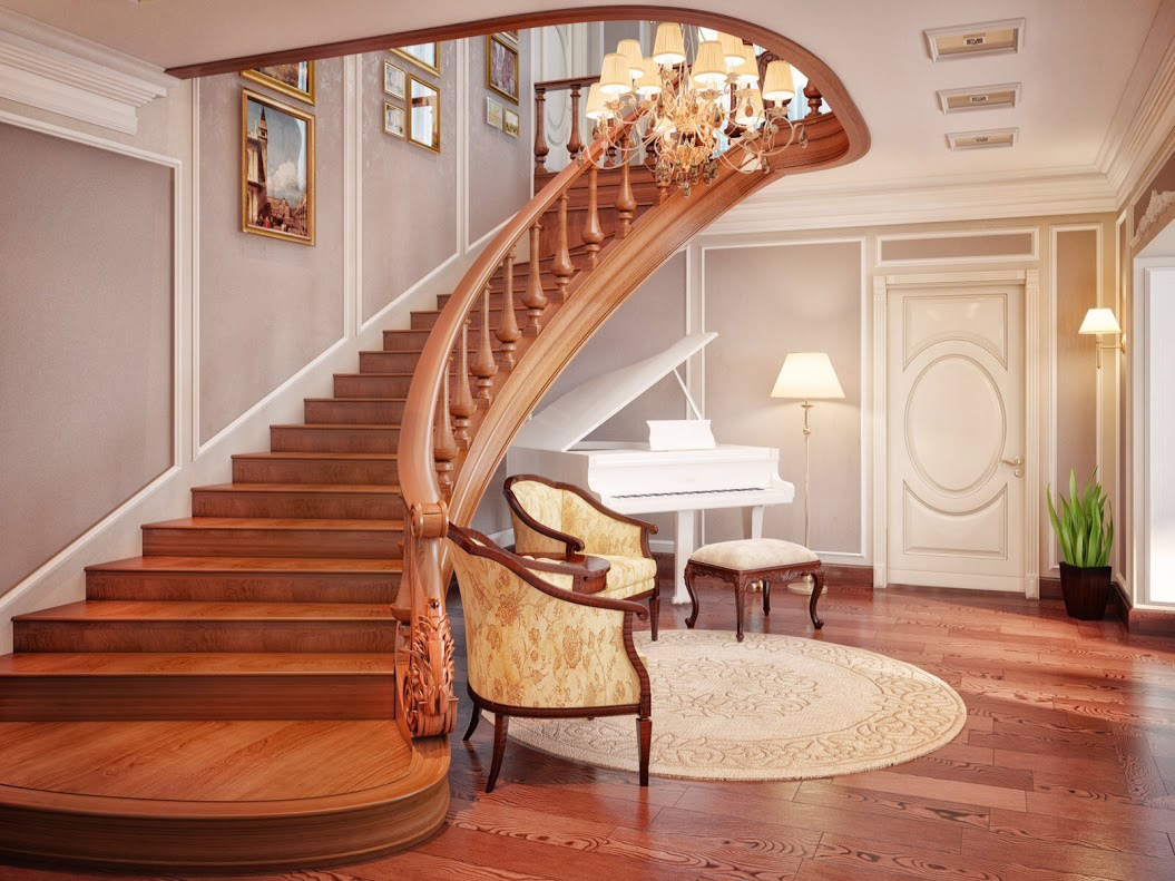 Large escalier en bois dans le hall d'une maison de campagne