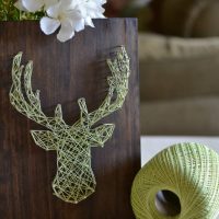 A moose figurine made of thread and carnations