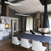 Metal fireplace in the interior of the living room of a rural house