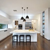 Brown kitchen floor with white walls.