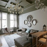 Four oval mirrors over the sofa